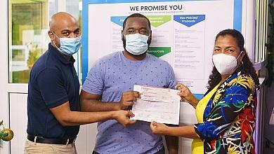 Jerrel Joseph (centre), winner of the Home is Where the HeART Is art competition with his prize-winning cheque
