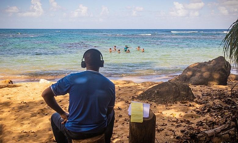 Man Looking At Children in Water Beach