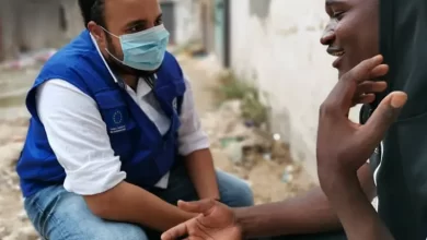 IOM Worker With Migrant