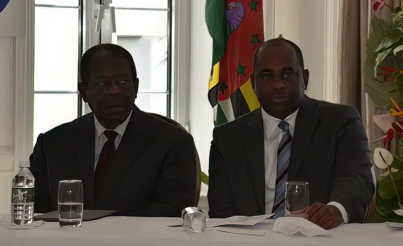 Prime Minister Roosevelt Skerrit sitting with Sir Dennis Byron