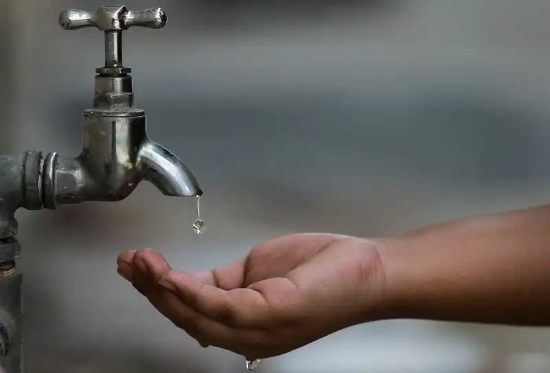 Drop of Water from Tap in Hand